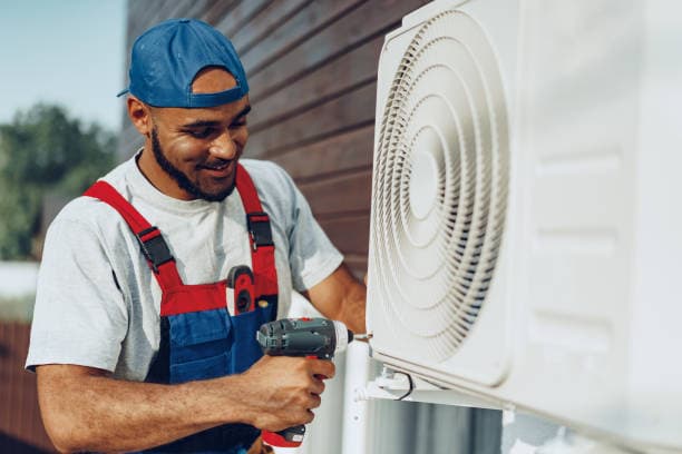 Professional HVAC technician servicing an air conditioning unit on a rooftop